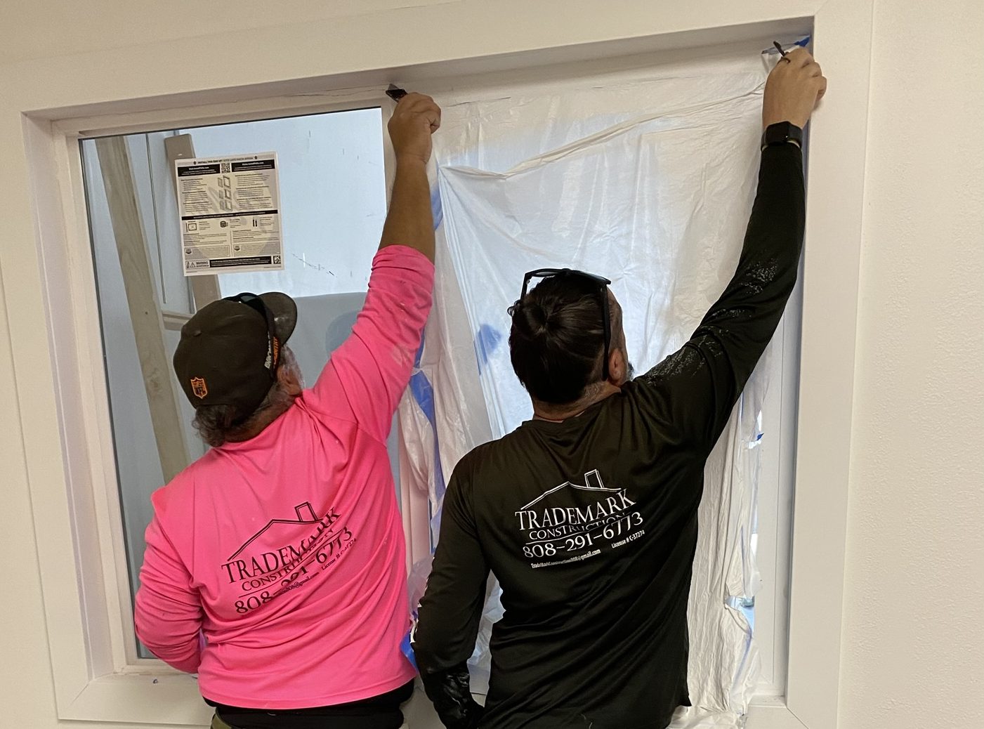 Mark and Joe removing an interior window during a remodel