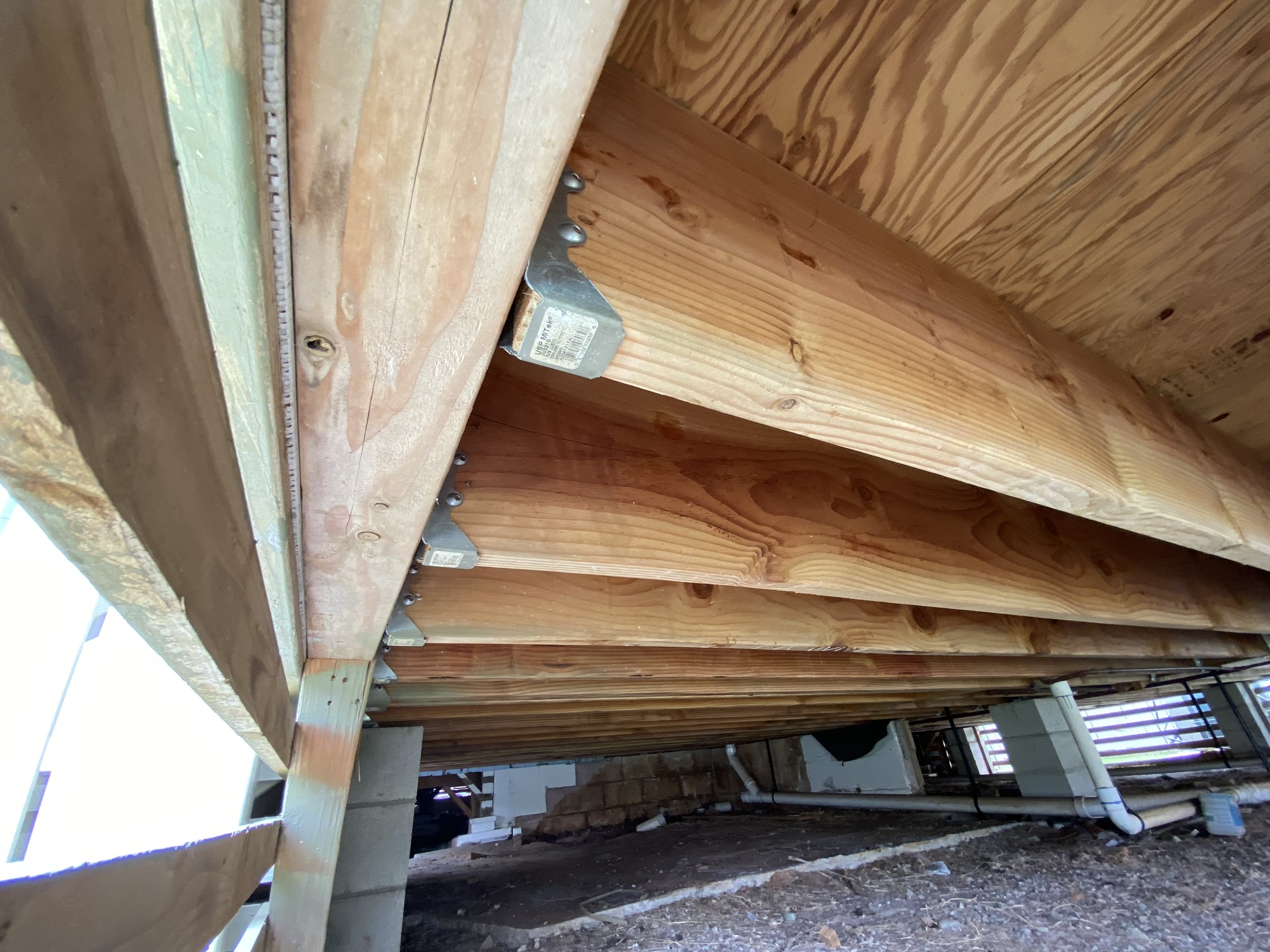 Structural framing and repair work beneath an Oʻahu home